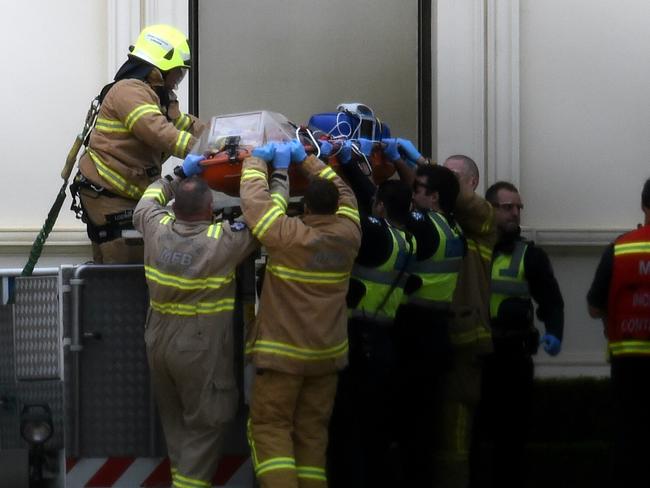 The man was carried down on a stretcher. Picture: Nicole Garmston