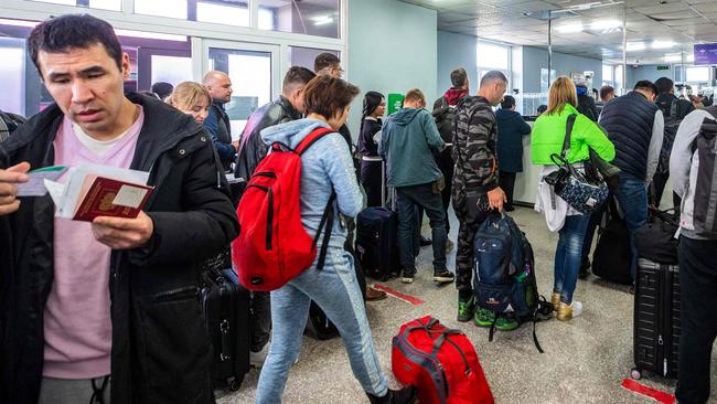 People arriving from Russia wait at the Mongolian border checkpoint of Altanbulag in September. Picture: AFP