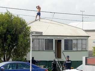 Rockhampton police try to talk a man down off a roof in Wood St, Depot Hill. Picture: Jann Houley