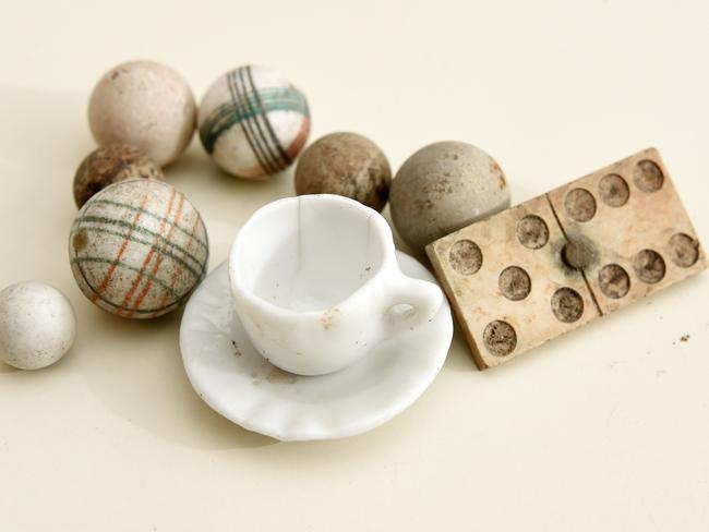 Painted clay marbles, a child's tea set and a domino found, all from the 1850s-1900s. Picture: Josie Hayden