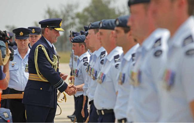 COUNTRY’S HONOUR: Chief of Air Force, Air Marshal Geoff Brown, presents combat badges to members of the Multi-National Base Command - Tarin Kot and Security Force at the welcome home parade. Picture: LAC Brenton Kwaterski