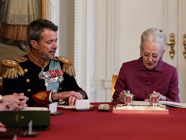 Queen Margrethe II of Denmark (R) signs a declaration of abdication as Crown Prince Frederik of Denmark (C) becomes King Frederik X of Denmark and Prince Christian of Denmark reacts in the Council of State at the Christiansborg Castle in Copenhagen, Denmark, on January 14, 2024. Denmark turns a page in its history on January 14 when Queen Margrethe abdicates and her son becomes King Frederik X, with more than 100,000 Danes expected to turn out for the unprecedented event. The change of throne takes place during the meeting of the Council of State at the moment when the queen has signed a declaration of abdication. (Photo by Mads Claus Rasmussen / Ritzau Scanpix / AFP) / Denmark OUT