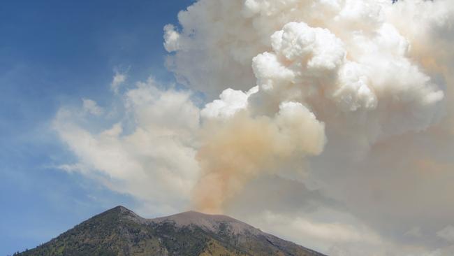 Mount Agung volcano erupts last June, stranding thousands of tourists. In the latest event, some flights were cancelled or diverted soon after. Picture: Sonny Tumbelaka/AFP