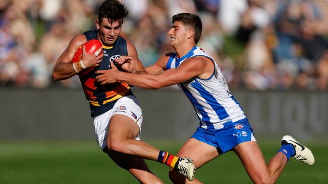 Crow Josh Rachele tries to evade Kangaroo Harry Sheezel during last Saturday’s 57-point win in Tasmania. Picture: Dylan Burns