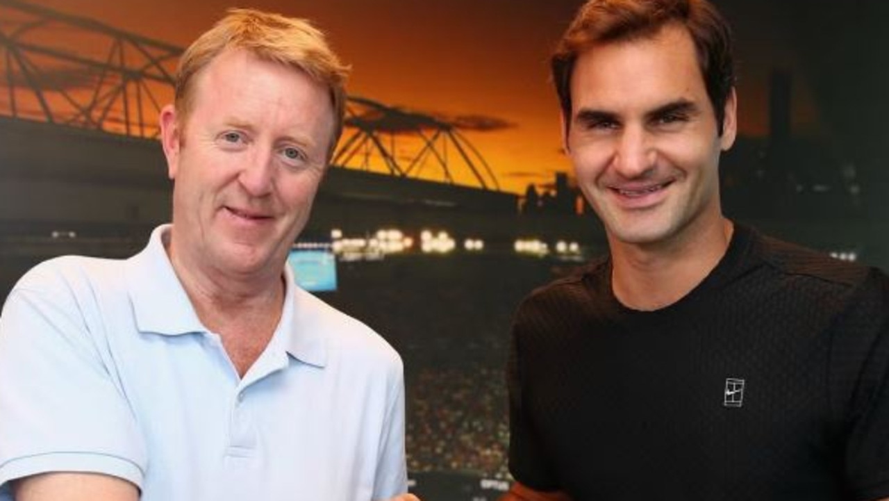 British tennis writer Mike Dickson, with Roger Federer, has died in Melbourne at the age of 59. Picture: Supplied