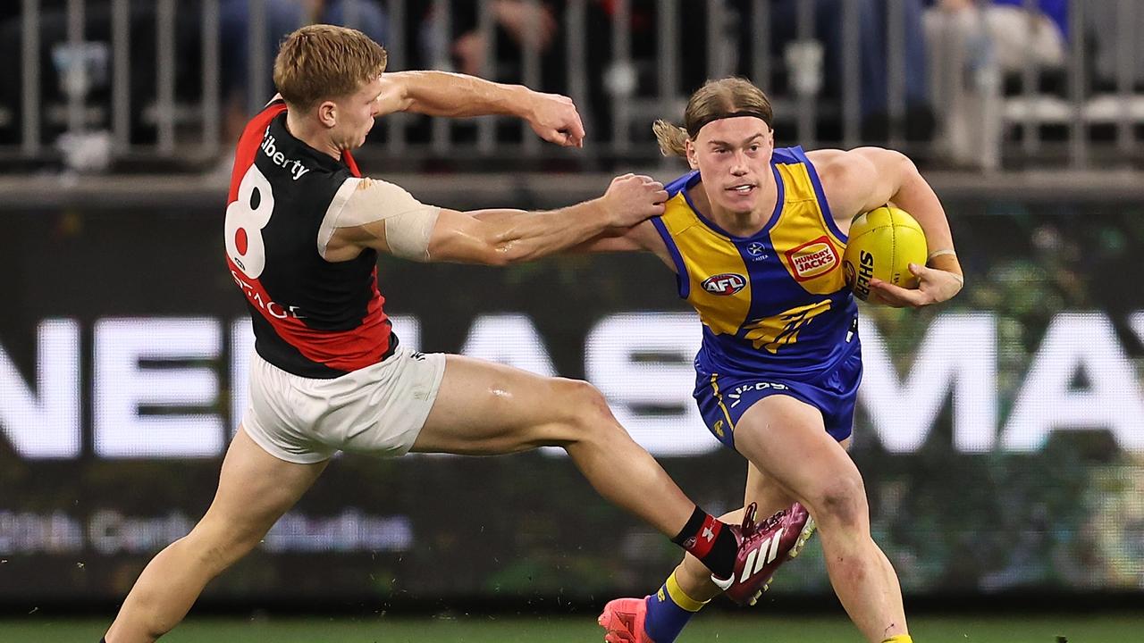 PERTH, AUSTRALIA - MAY 04: Harley Reid of the Eagles fends off Ben Hobbs of the Bombers during the round eight AFL match between West Coast Eagles and Essendon Bombers at Optus Stadium, on May 04, 2024, in Perth, Australia. (Photo by Paul Kane/Getty Images)