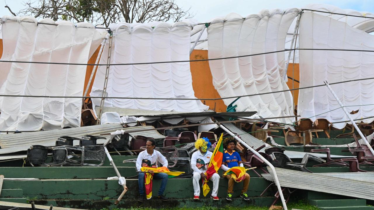 Sri Lankan fans sit in front of the collapsed stand, which forced a four-hour delay to play in the first Test at the Galle International Cricket Stadium. Picture: Ishara S. Kodikara/AFP