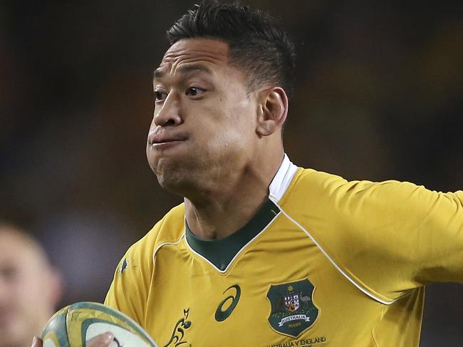 FILE - In this June 25, 2016, file photo, Australian rugby union player Israel Folau, wearing tape on his wrist adorned with a cross, runs toward the try line to score against England during their rugby union test match in Sydney. The 30-year-old Folau will appear before a code of conduct hearing at Rugby Australia's headquarters in Sydney to determine the playing future of the star Wallabies fullback on Saturday, May 4, 2019. (AP Photo/Rick Rycroft, File)