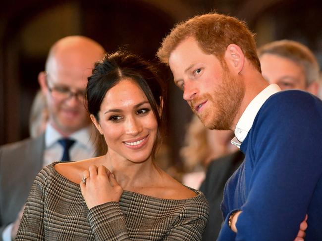 CARDIFF, WALES - JANUARY 18:  Prince Harry whispers to Meghan Markle as they watch a dance performance by Jukebox Collective in the banqueting hall during a visit to Cardiff Castle on January 18, 2018 in Cardiff, Wales. (Photo by Ben Birchall - WPA Pool / Getty Images)