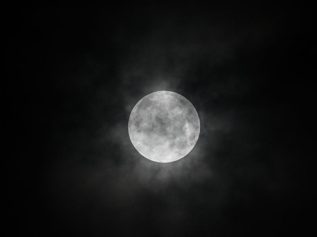 Rain cloud over the moon during a partial lunar eclipse, in Yangon on July 17, 2019. (Photo by Ye Aung THU / AFP)