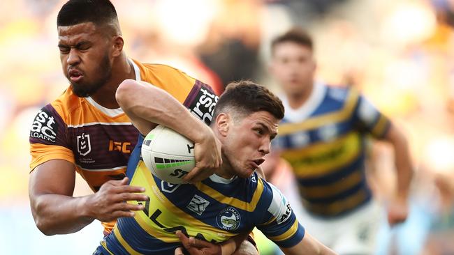 Mitchell Moses is tackled by Payne Haas during the game against the Broncos.