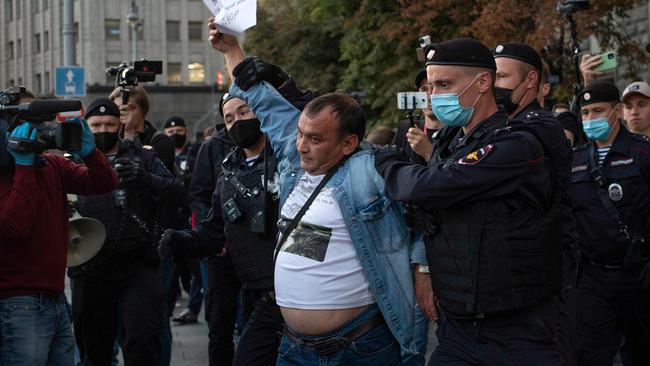 Police officers detain a Navalny supporter during a protest in Moscow on Thursday. Picture: AFP