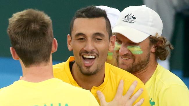 Nick Kyrgios reacts with team mates, to winning the match for Australia against Sam Querrey from the USA. Colour and action at the Davis Cup Tie between Australia and the USA. Picture: Jono Searle.
