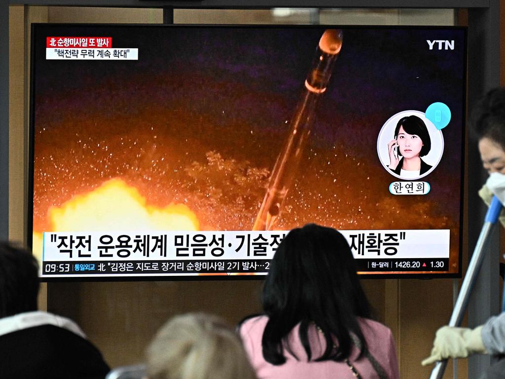 A TV shows a news broadcast with file footage of a North Korean missile test. Picture: AFP