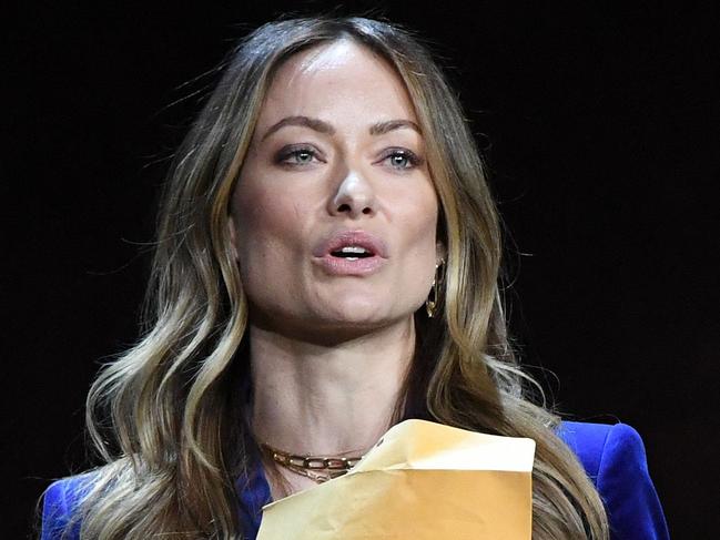 US director and actress Olivia Wilde holds an envelope reading 
