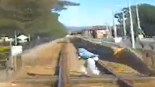 A pedestrian runs across a train line just seconds from a passing train – which can take up to 500m to stop and travel at speeds of up to 110km/h. Picture: Supplied