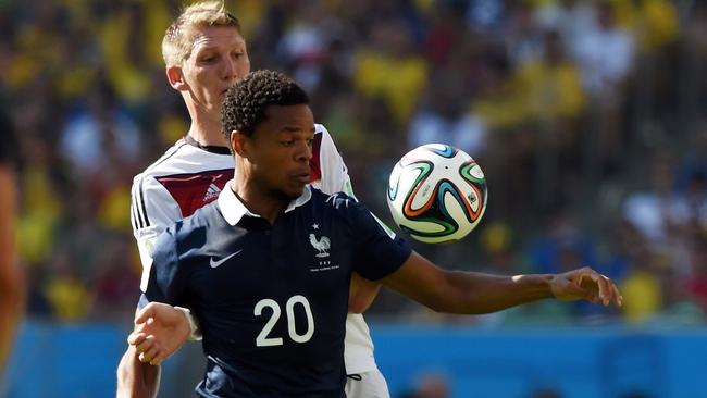 France's forward Loic Remy (front) and Germany's midfielder Bastian Schweinsteiger vie for the ball during the quarter-final football match between France and Germany at the Maracana Stadium in Rio de Janeiro during the 2014 FIFA World Cup on July 4, 2014. AFP PHOTO / PEDRO UGARTE