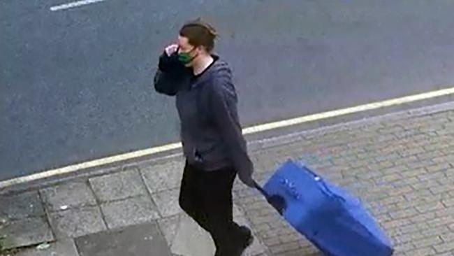 Jemma Mitchell on Chaplin Road, north west London dragging a blue suitcase on June 11 2021.