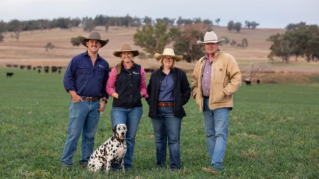 Ed Thomas, Caitlin Herbert, Tess Herbert and Andrew Herbert (with dog Penny) on the family farm. Picture: Kim Storey