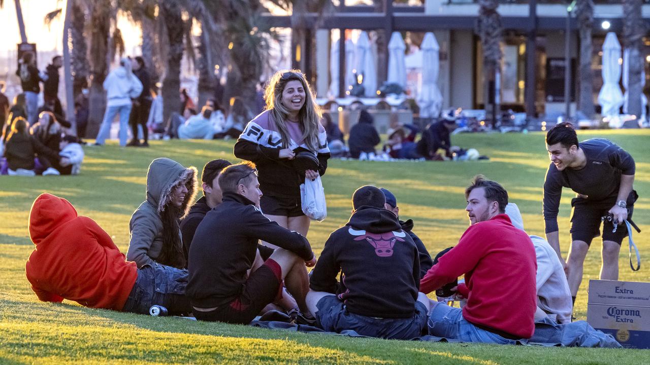 People gather at St Kilda Beach on Sunday afternoon as the weather warms up during Covid lockdown six in Melbourne. Picture: David Geraghty