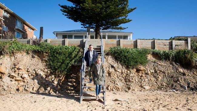 Going, going, gone: Eugene Marchese with his wife Jo Marchese with their house in Wamberal. Picture: Ryan Osland
