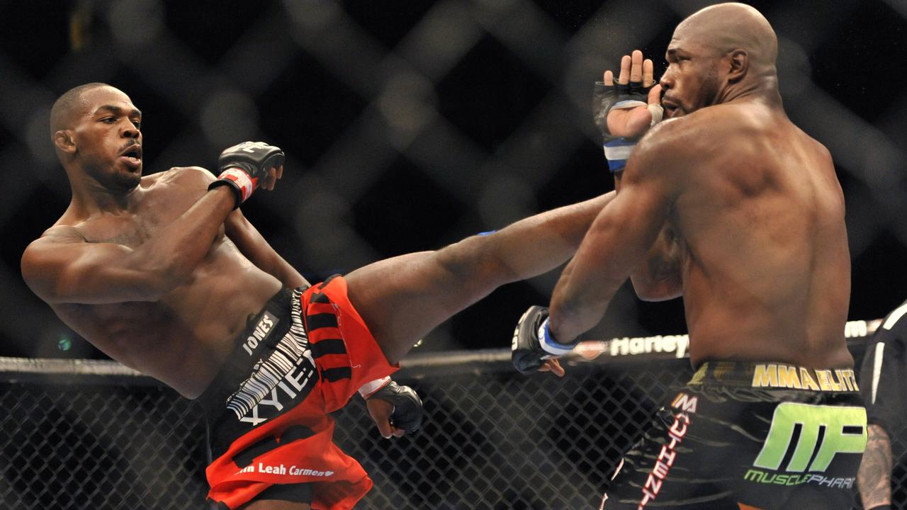 Jon Jones, left, of Endicott, N.Y., gets in a kick to the head of Rampage Jackson, of Irvine, Calif., during the first round of their UFC Light Heavyweight title bout, Saturday, Sept. 24, 2011, in Denver. (AP Photo/ Jack Dempsey )