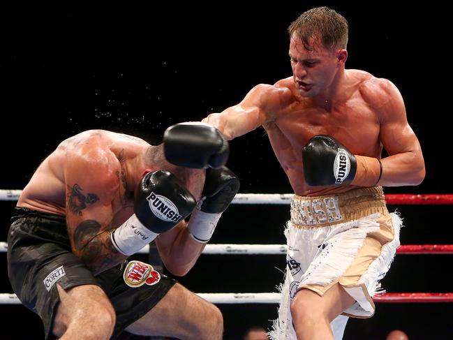 Boxers Rolando Mansilla and Rohan Murdock in action during the All Or Nothing boxing match at the Brisbane Convention & Exhibition Centre (BCEC) in Brisbane, Saturday, December 15, 2018. (AAP Image/Jono Searle)