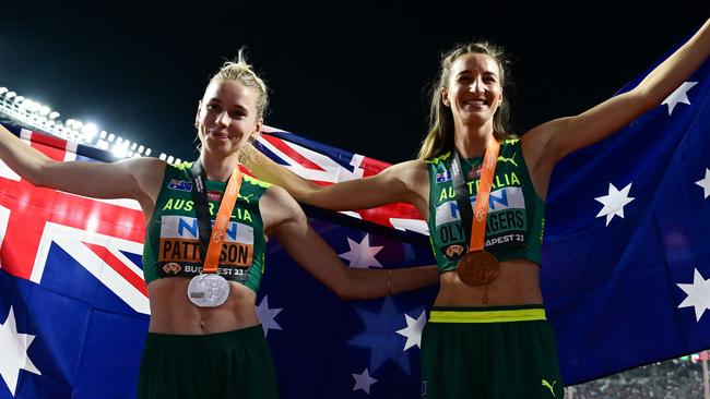 Silver medalist, Australia's Eleanor Patterson (L) and bronze medalist, Australia's Nicola Olyslagers (R) celebrate with their National flags and medals after the women's high jump final during the World Athletics Championships at the National Athletics Centre in Budapest on August 27, 2023. (Photo by Ben Stansall / AFP)