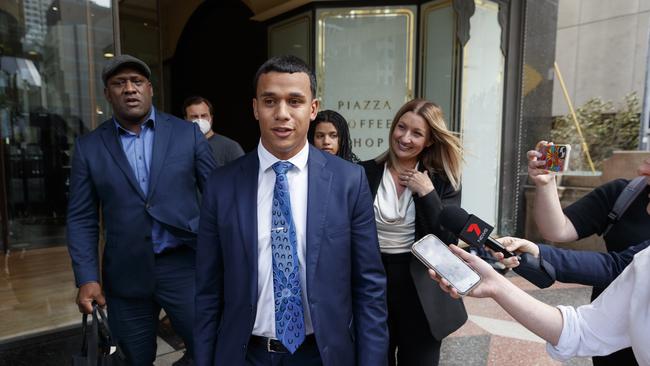 SYDNEY, AUSTRALIA – NewsWire Photos MARCH 31, 2022: Footballer, Tristan Sailor (centre in blue suit and tie) leaving Downing Centre courts this afternoon after being found not guilty. Picture: NCA NewsWire / David Swift