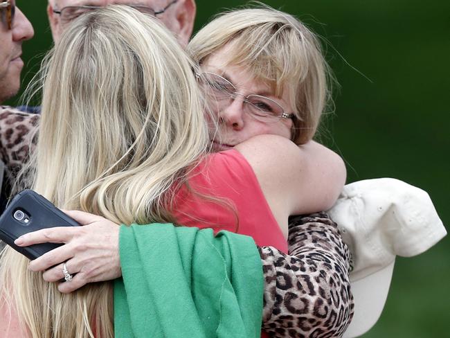 Sandy Phillips embraces a friend as she leaves the Arapahoe County Courthouse in August, 2015. Picture: David Zalubowski