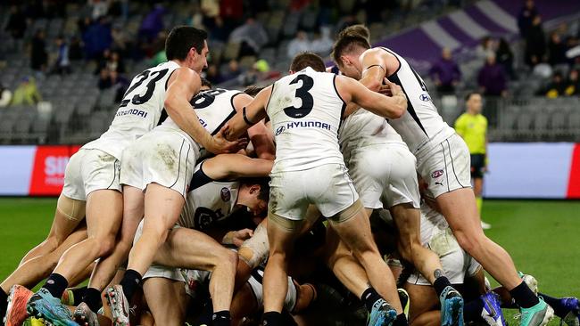 Newnes is mobbed by teammates after his goal. Picture: AFL Photos