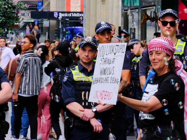 MELBOURNE AUSTRALIA - NewsWire Photos NOVEMBER 17, 2024: Pro-Palestinian protestors are seen along Bourke St Mall as retail giant Myer unveils its much-loved Christmas windows display.Picture: NewsWire / Luis Enrique Ascui