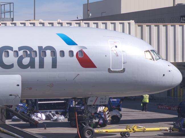 Phoenix, Arizona, USA - September 19, 2017: An American Airlines Boeing jet at the Phoenix International Airport being refueled and boarded. There is a luggage handler working.