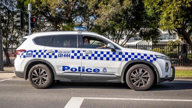 Police drive past the school as they carry out patrols. Picture: Jake Nowakowski