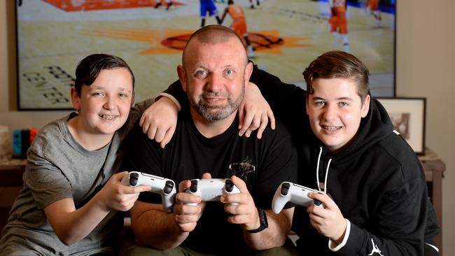 James Fahey enjoys playing video games with his sons Tristan, 14, and Jesse, 16. Picture: Andrew Henshaw