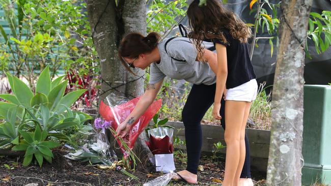 41-year-old Emma Lovell was stabbed during a home invasion in North Lakes on Boxing Day. A mother and daughter leave flowers at the Whitfield Crescent address. Picture: David Clark