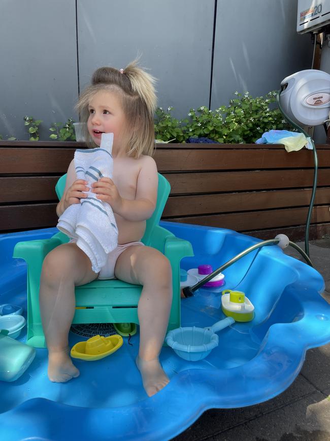 Mia Makinson, 2, loves a water icypole on a hot day. She enjoys sitting in her favourite backyard chair, in her wading pool with the hose running. Picture: Gail Makinson, Werribee.