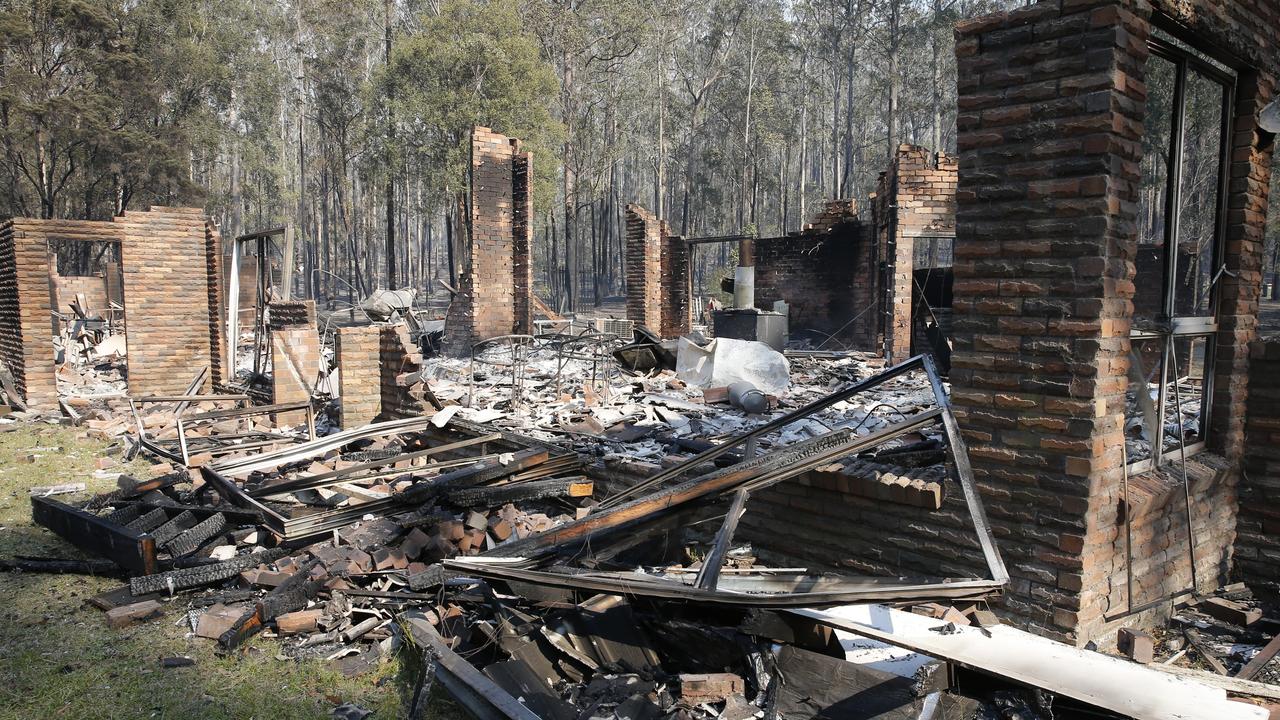 The remains of the residence at Four Paws boarding kennels smoulders along the Pacific Highway south of Taree. Picture: AAP/Darren Pateman