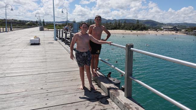 Jetty jumping is a holiday tradition for many in Coffs. Cody Woodwell and Jayden Coombes from Arrawarra prepare to take the plunge. Picture: Coffs Coast Advocate/Chris Knight