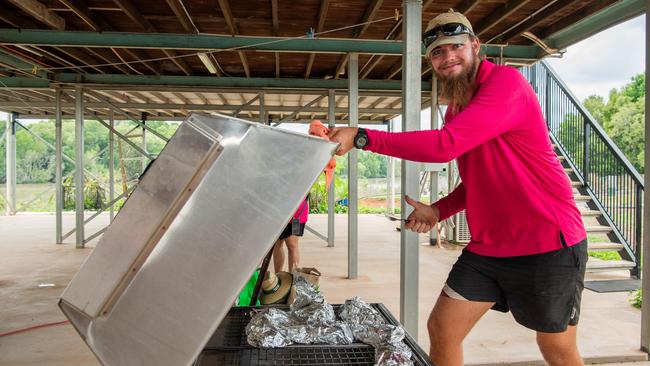 Kel McLachlan smokes the fish as local farm Humpty Doo Barra celebrates National Barra Day. Picture: Pema Tamang Pakhrin