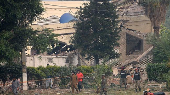 Paramilitary soldiers inspect a collapsed building of the Government Health and Educational complex after Indian strikes in Muridke, about 30km from Lahore. Picture: AFP