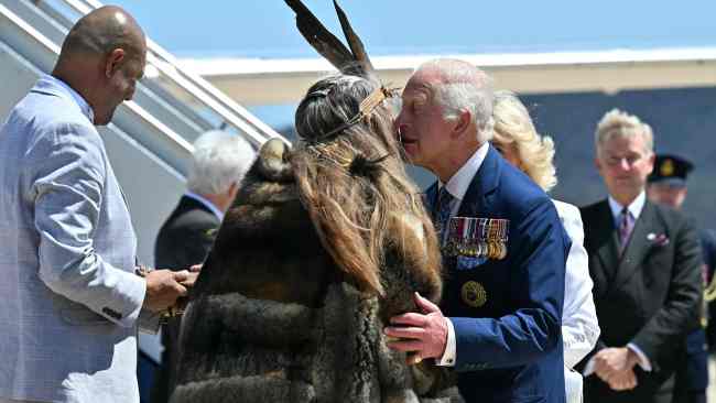 Ngunnawal Elder Aunty Serena Williams warmly embraces Charles upon his arrival in Canberra. Picture: Saeed KHAN / POOL / AFP