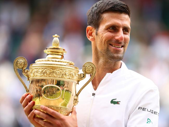 LONDON, ENGLAND - JULY 11: Novak Djokovic of Serbia celebrates with the trophy after winning his men's Singles Final match against Matteo Berrettini of Italy on Day Thirteen of The Championships - Wimbledon 2021 at All England Lawn Tennis and Croquet Club on July 11, 2021 in London, England. (Photo by Julian Finney/Getty Images)