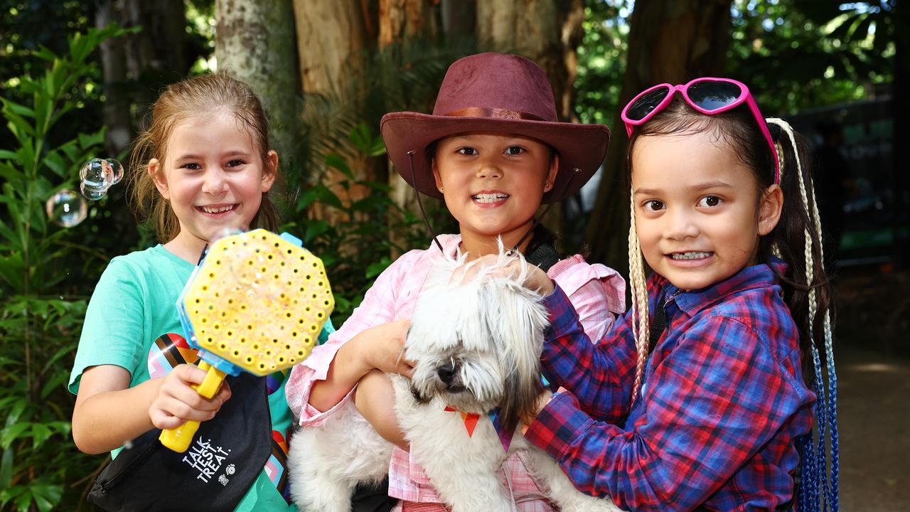 Mackenzie Powman, Ellis Savage, 8, and Reese Savage, 6, with Cha Cha the maltese shi tzu cross attend the Cairns Pride Festival's Pride Fair day, held at the Tanks Arts Centre, Edge Hill. Picture: Brendan Radke