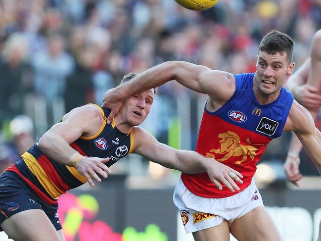 ADELAIDE, AUSTRALIA - MAY 12: Rory Laird of the Crows tackles Josh Dunkley of the Lions during the 2024 AFL Round 09 match between the Adelaide Crows and the Brisbane Lions at Adelaide Oval on May 12, 2024 in Adelaide, Australia. (Photo by James Elsby/AFL Photos via Getty Images)