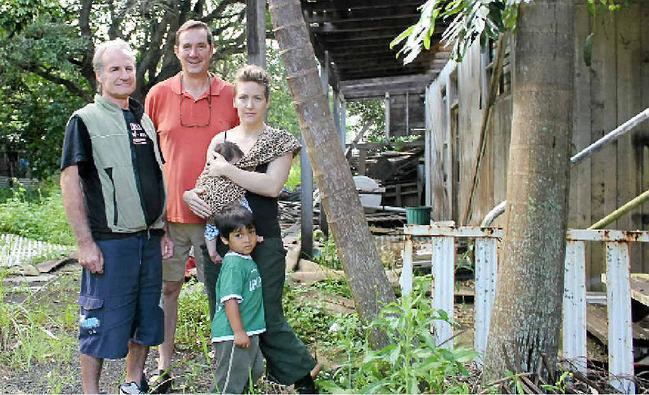 CONCERNS: Little Keen St residents, in front of the house planned for demolition, are (from left) John Trapp, Tony Gilding, Jade Bening with baby Loretta and Django Bening.