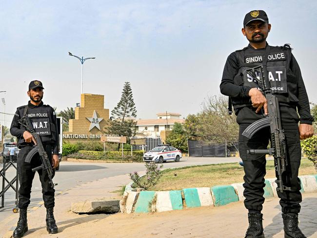 Pakistan's police commandos stand guard outside the National Stadium in Karachi on February 17, 2025. The Champions Trophy begins on February 19 after a turbulent build-up that saw the tournament split between Pakistan and Dubai, and with England facing calls to boycott their match against Afghanistan. The event, regarded as second only to the World Cup in the one-day game, runs until March 9 and is the first global cricket tournament hosted by Pakistan in nearly three decades. (Photo by Asif HASSAN / AFP)