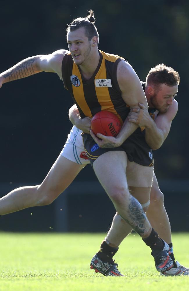 Dillan Ronalds (right) lays a big tackle against Heidelberg West. Picture: Stuart Milligan