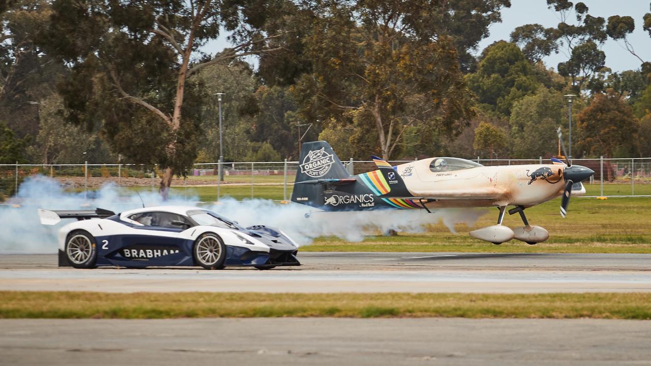 The plane up against David Brabham in the Brabham BT62 supercar. Picture: Matt Loxton