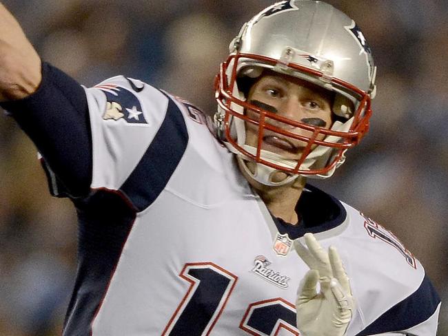 SAN DIEGO, CA- DECEMBER 7: Tom Brady #12 of the New England Patriots throws for a first down against the San Diego Chargers during an NFL game at Qualcomm Stadium on December 7, 2014 in San Diego, California. Donald Miralle/Getty Images/AFP == FOR NEWSPAPERS, INTERNET, TELCOS & TELEVISION USE ONLY ==